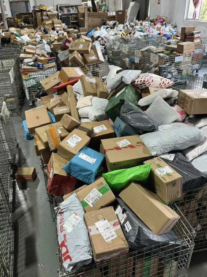 Packed parcels with DHL and courier labels staged on the shipping floor